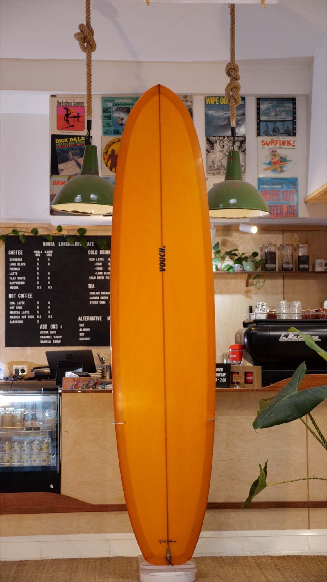 8'7" Vouch Rolled Vee 1 burnt orange tint deck and bottom, polished black band on bottom