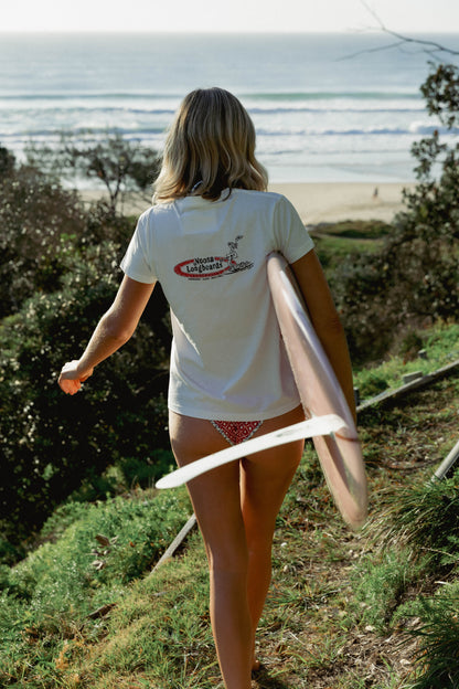 Womens Shealoha 2k25 worn walking towards the coast with a pink surfboard near Sunshine Beach