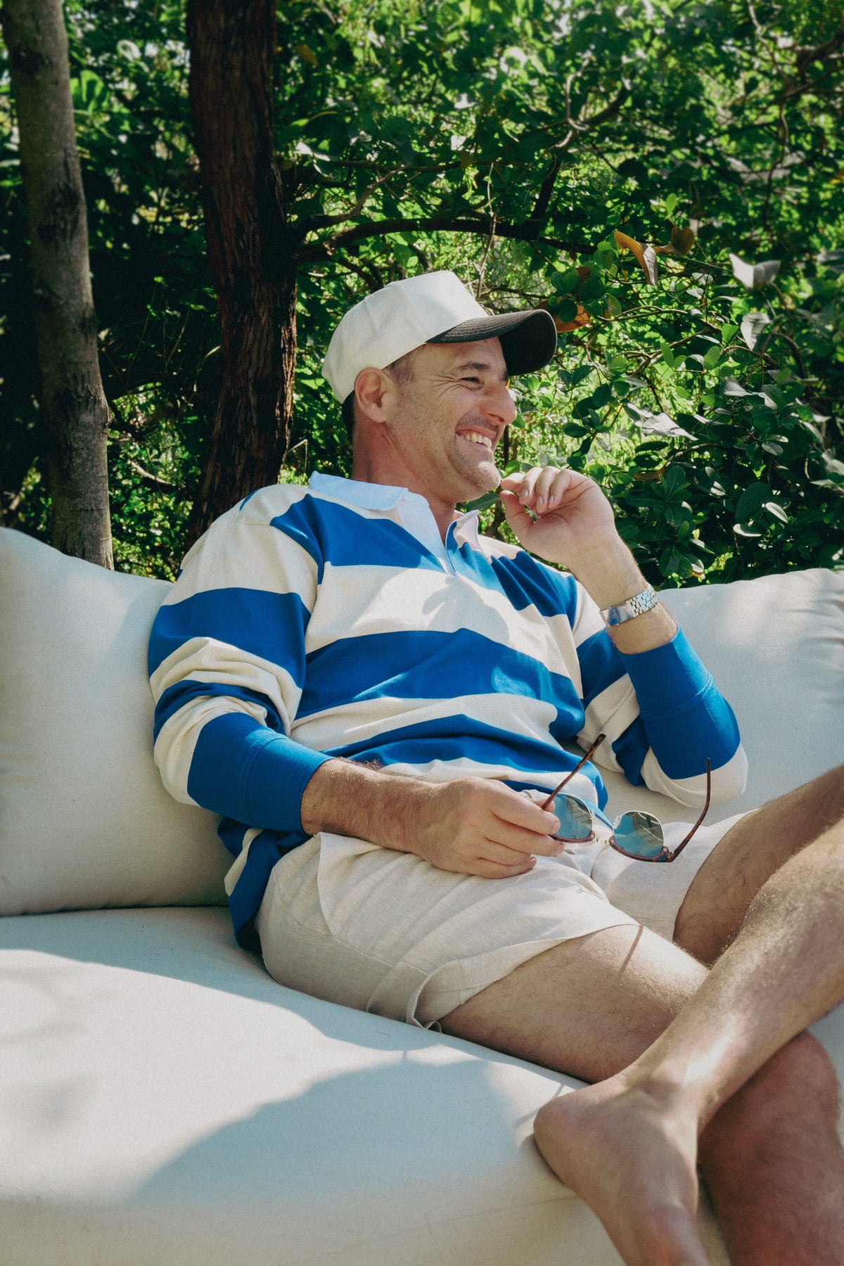 NL Rugby Jersey Cream/Blue worn seated on a garden sofa at Domic, Sunshine Beach
