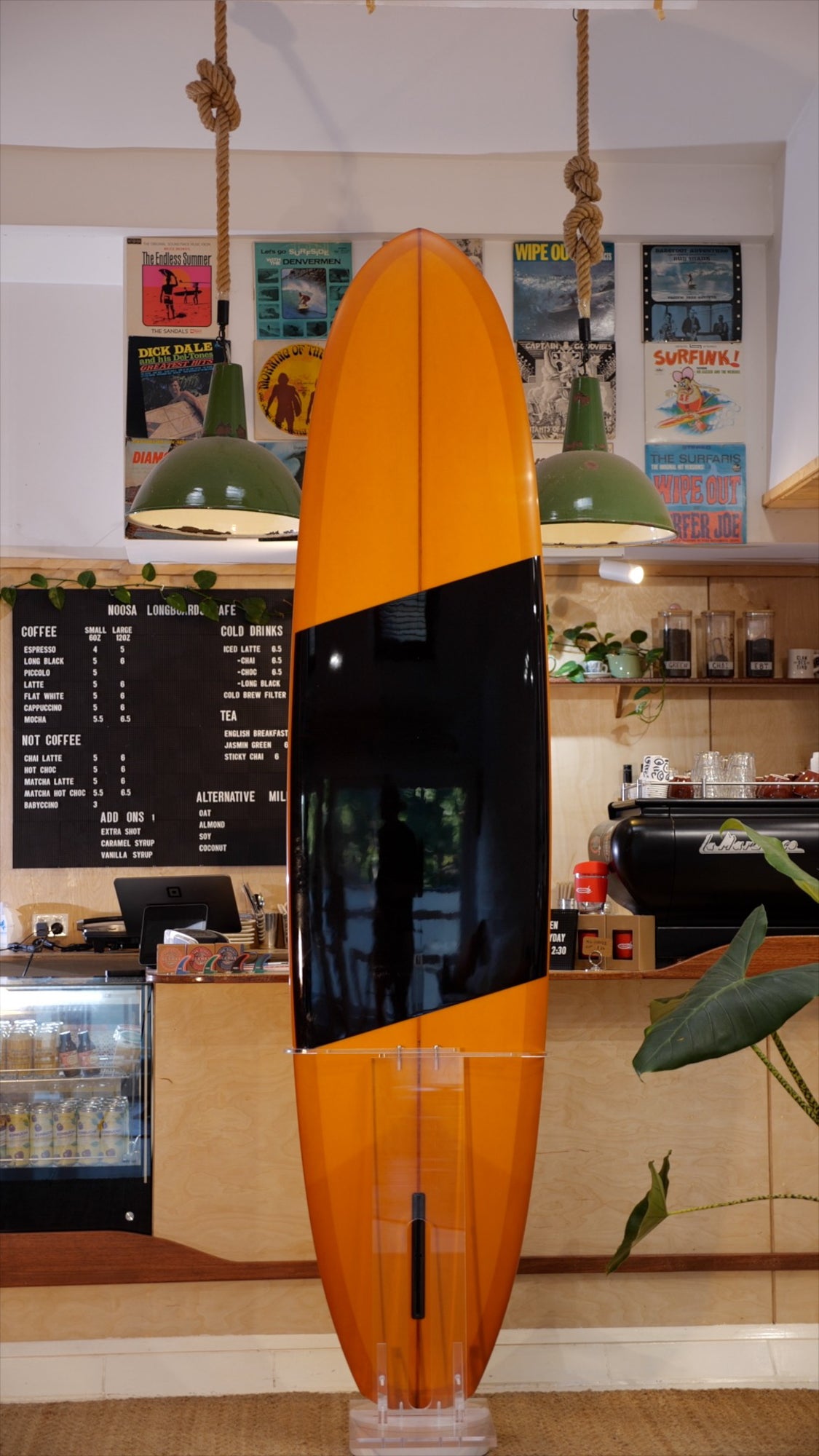 8'7" Vouch Rolled Vee 1 burnt orange tint deck and bottom, polished black band on bottom