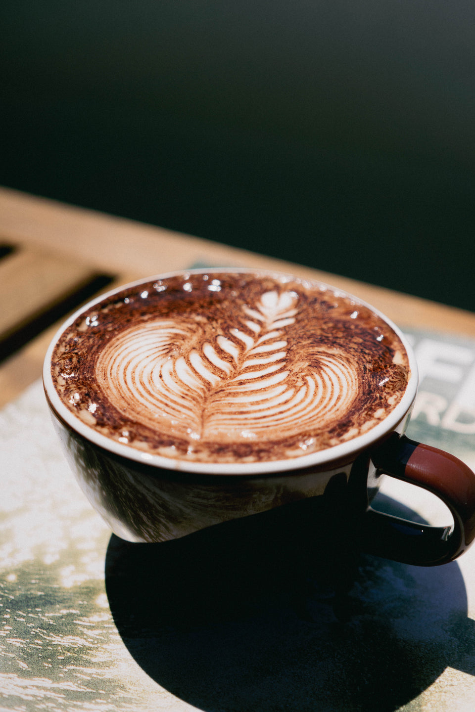 Freshly poured coffee with latte art upstairs at Noosa Longboards